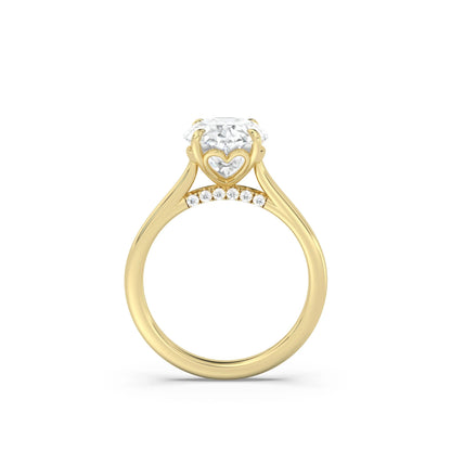 Yellow gold engagement ring with hidden hearts in the setting and a lab diamond pave bridge