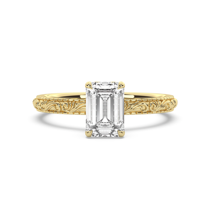 Engraved gold ring with emerald-cut diamond on a white background