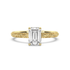 Engraved gold ring with emerald-cut diamond on a white background