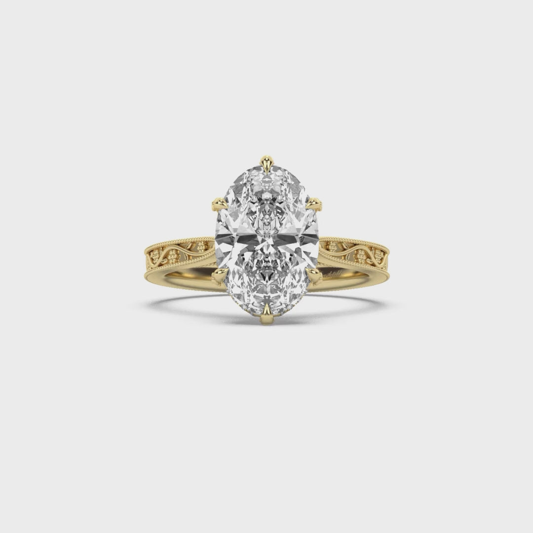 Oval yellow gold engagement ring with floral engraved band by castlefield collection