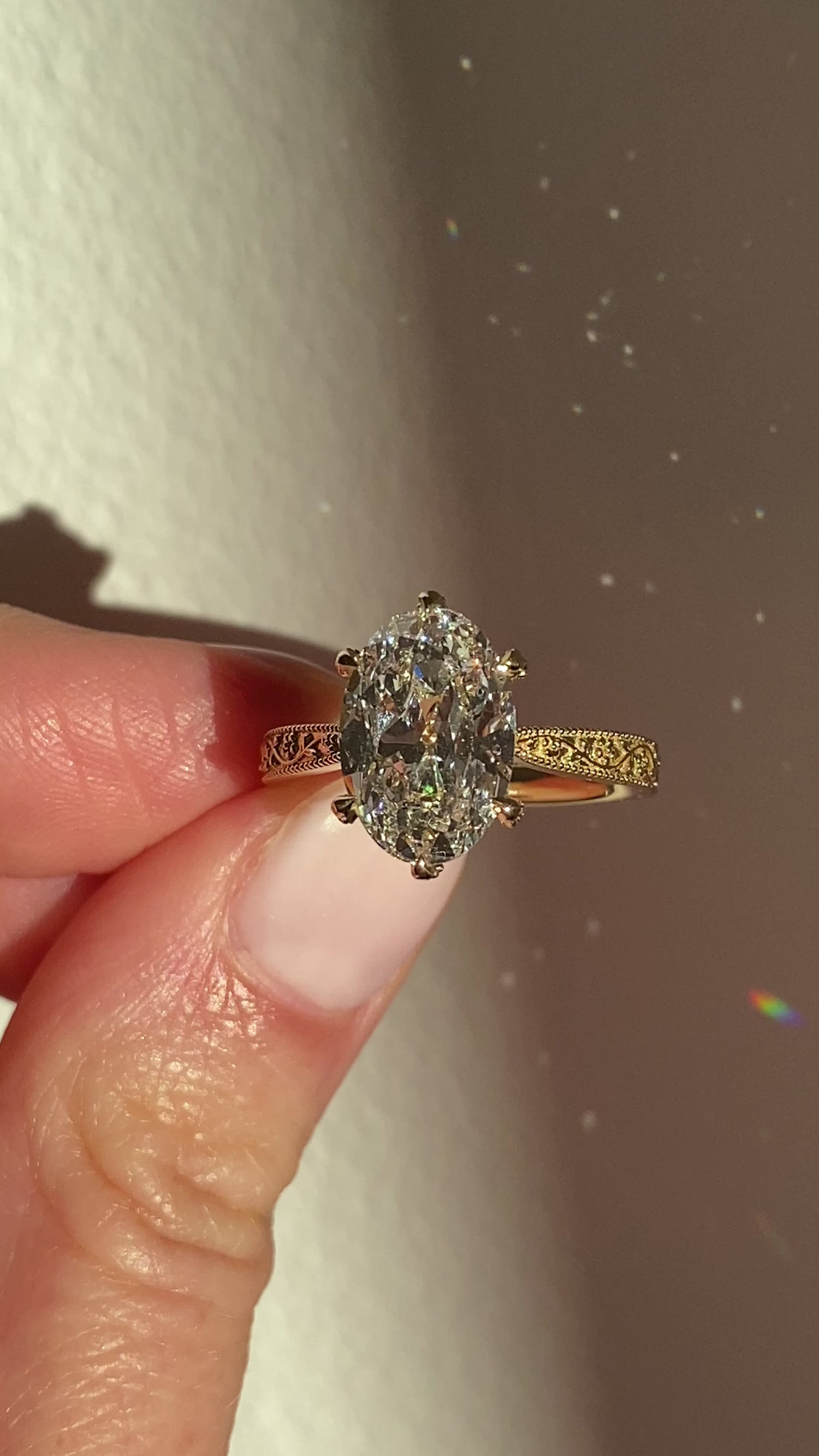 Oval yellow gold engagement ring with floral engraved band by castlefield collection