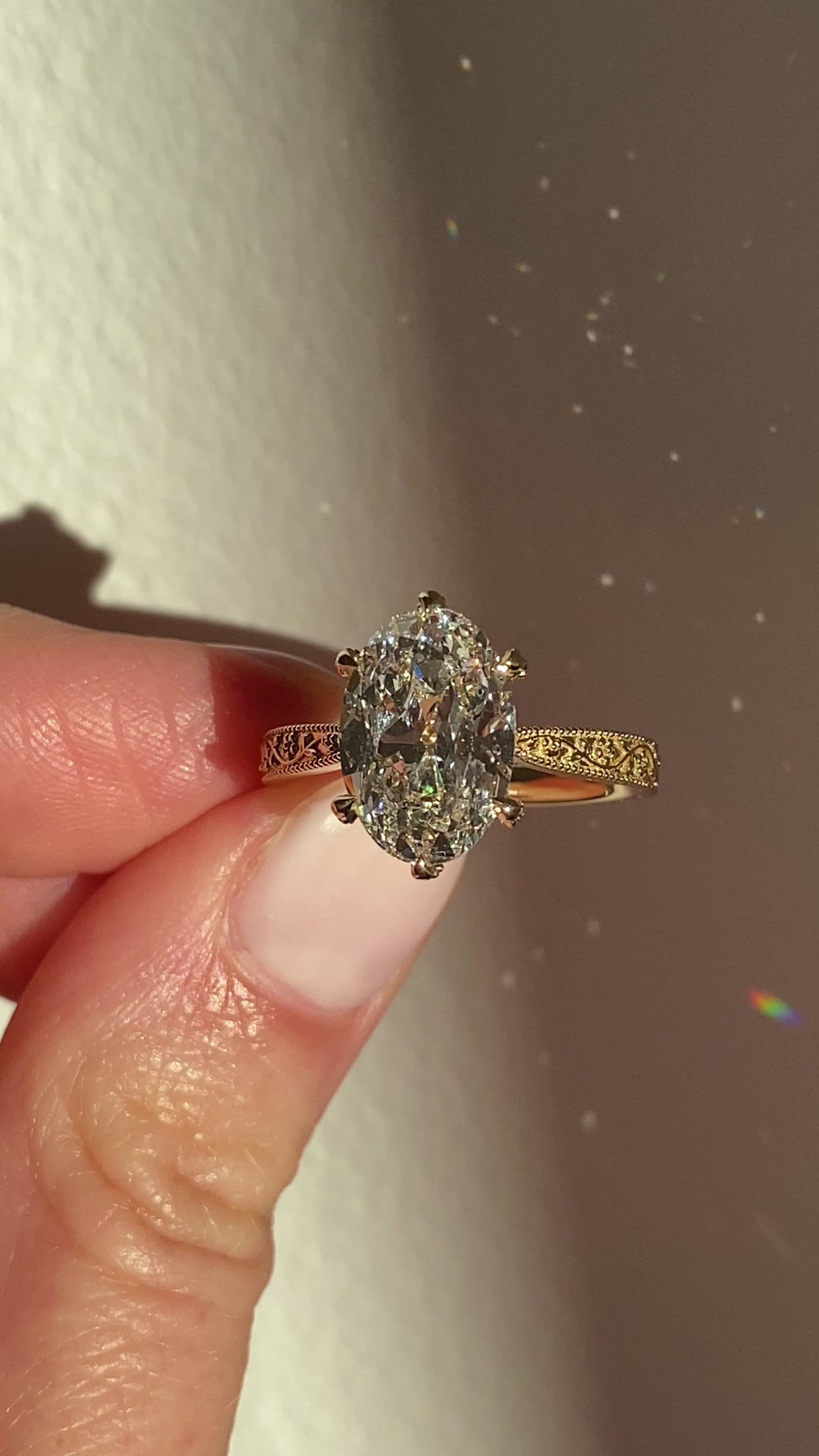 Oval yellow gold engagement ring with floral engraved band by castlefield collection